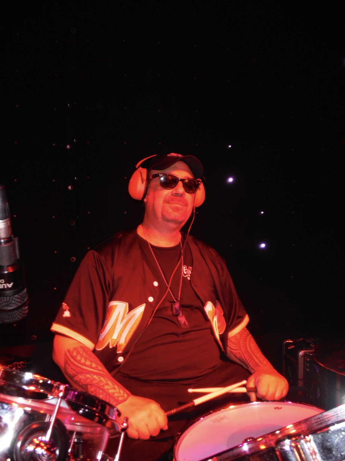 Live drummer under red light
